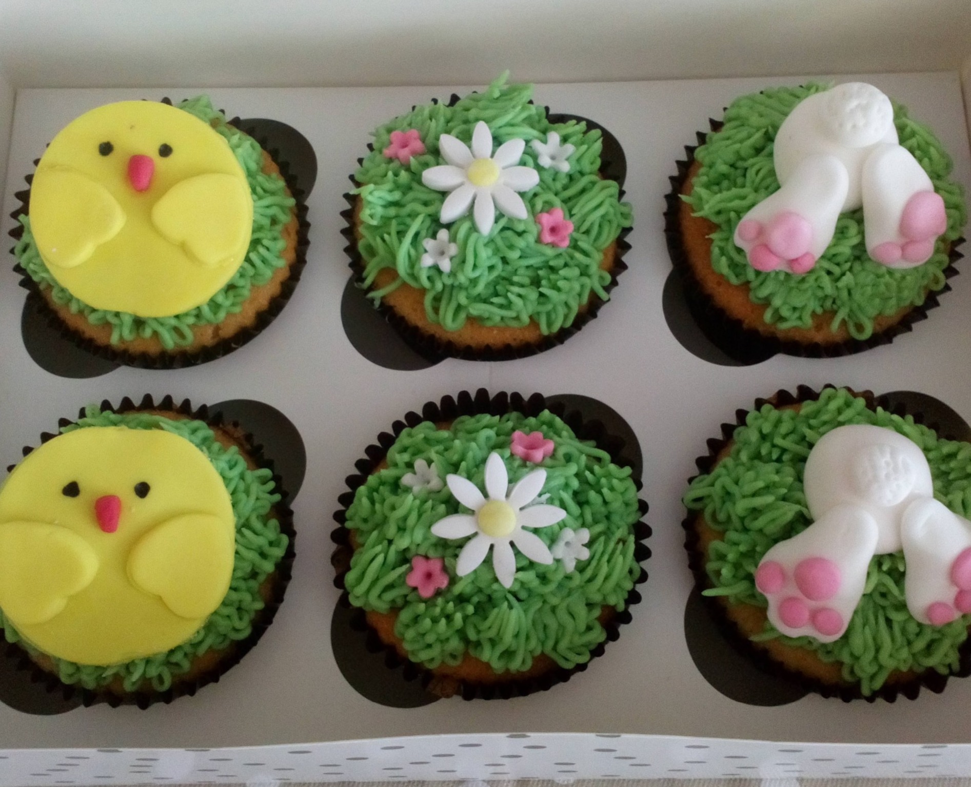 Box of Easter chicks and bunnies cupcakes
