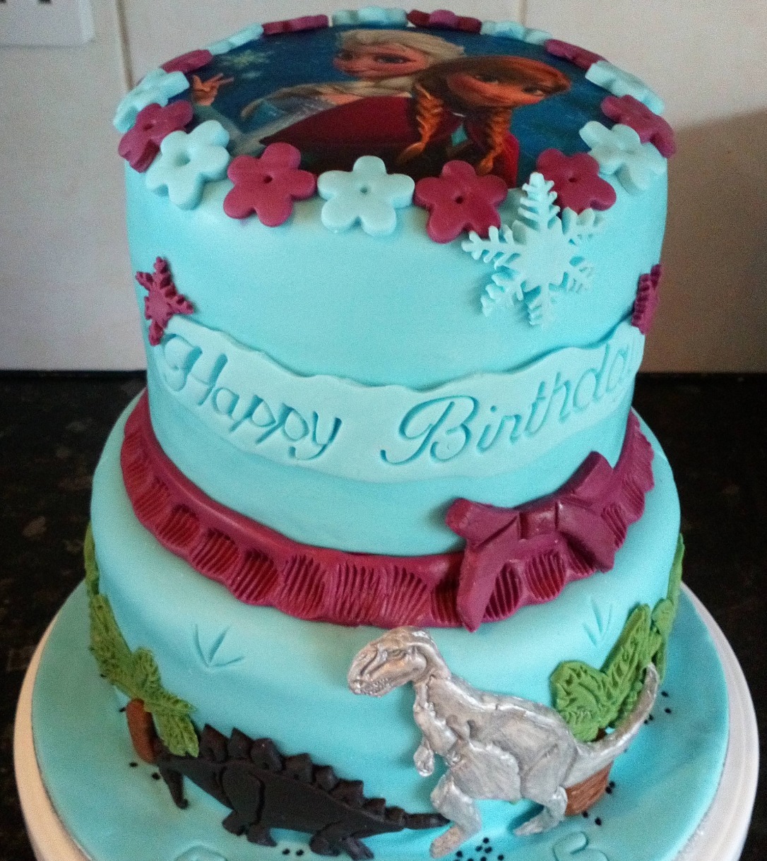 two tier frozen and dinosaur 5th birthday cake