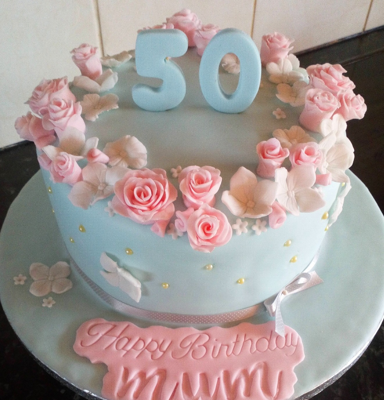 Blue birthday cake with pink handmade roses