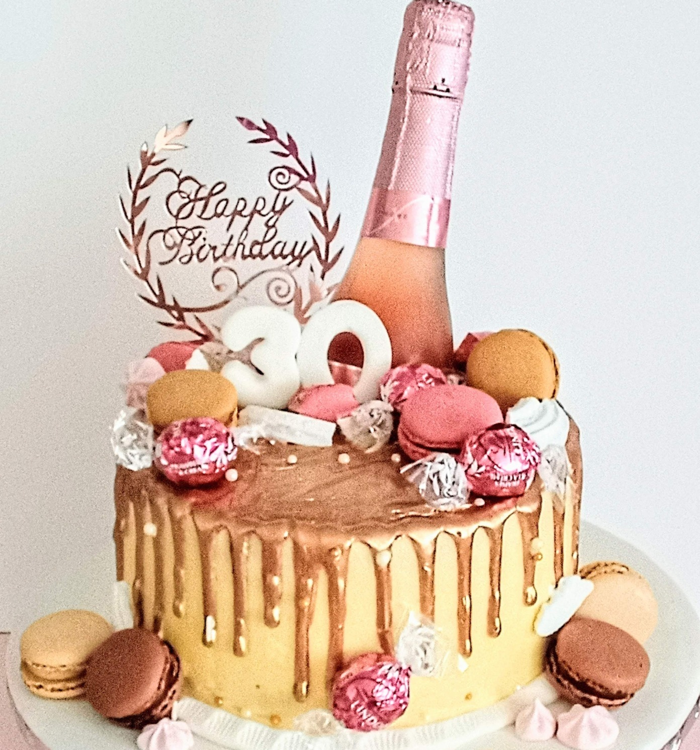 Buttercream rose gold drip cake with champagne