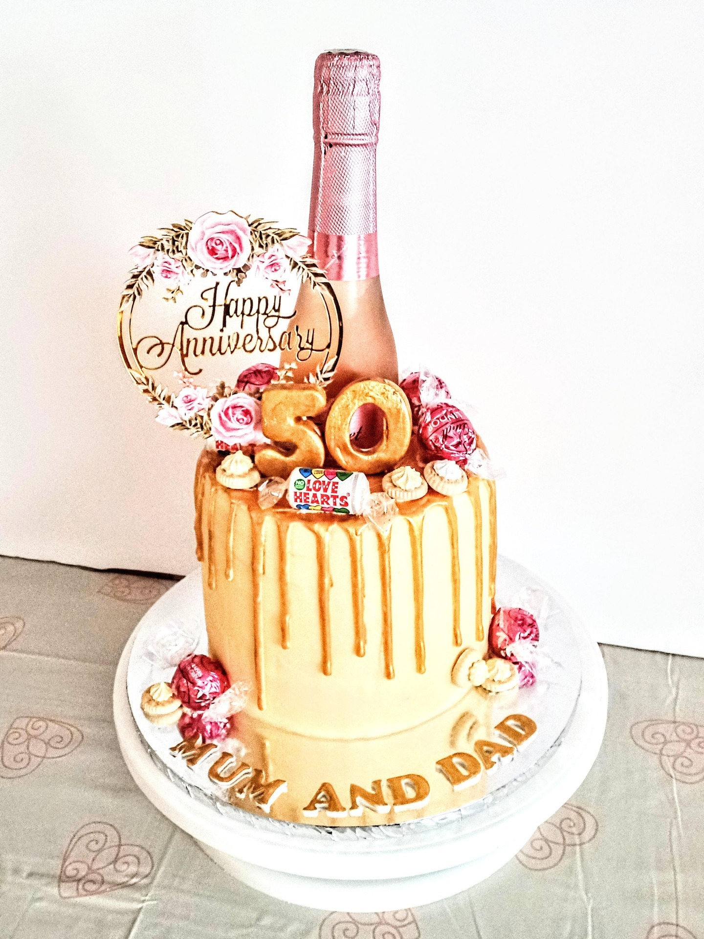 50th wedding drip cake with champagne bottle