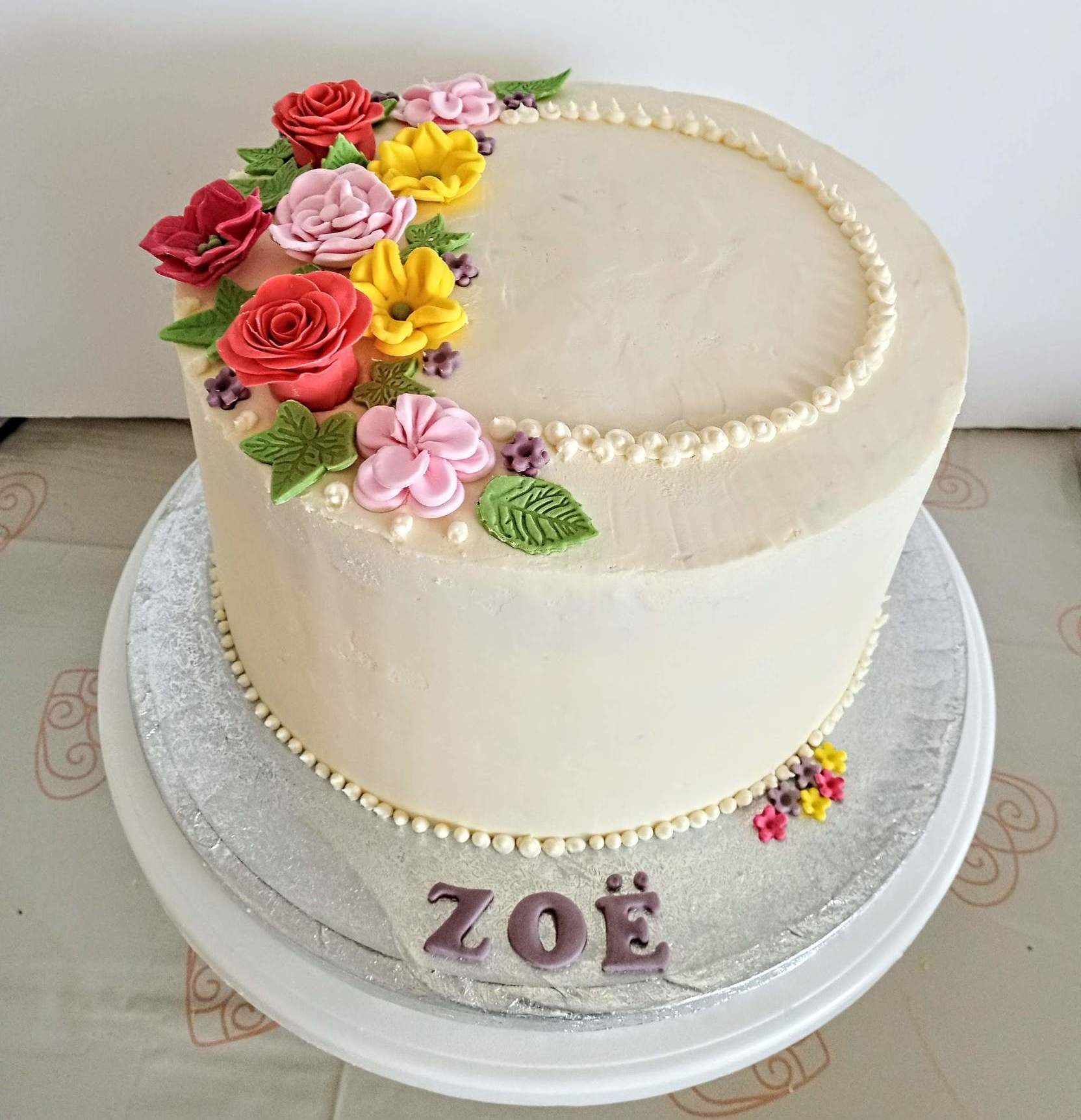 Ladies elegant buttercream cake with fondant flowers