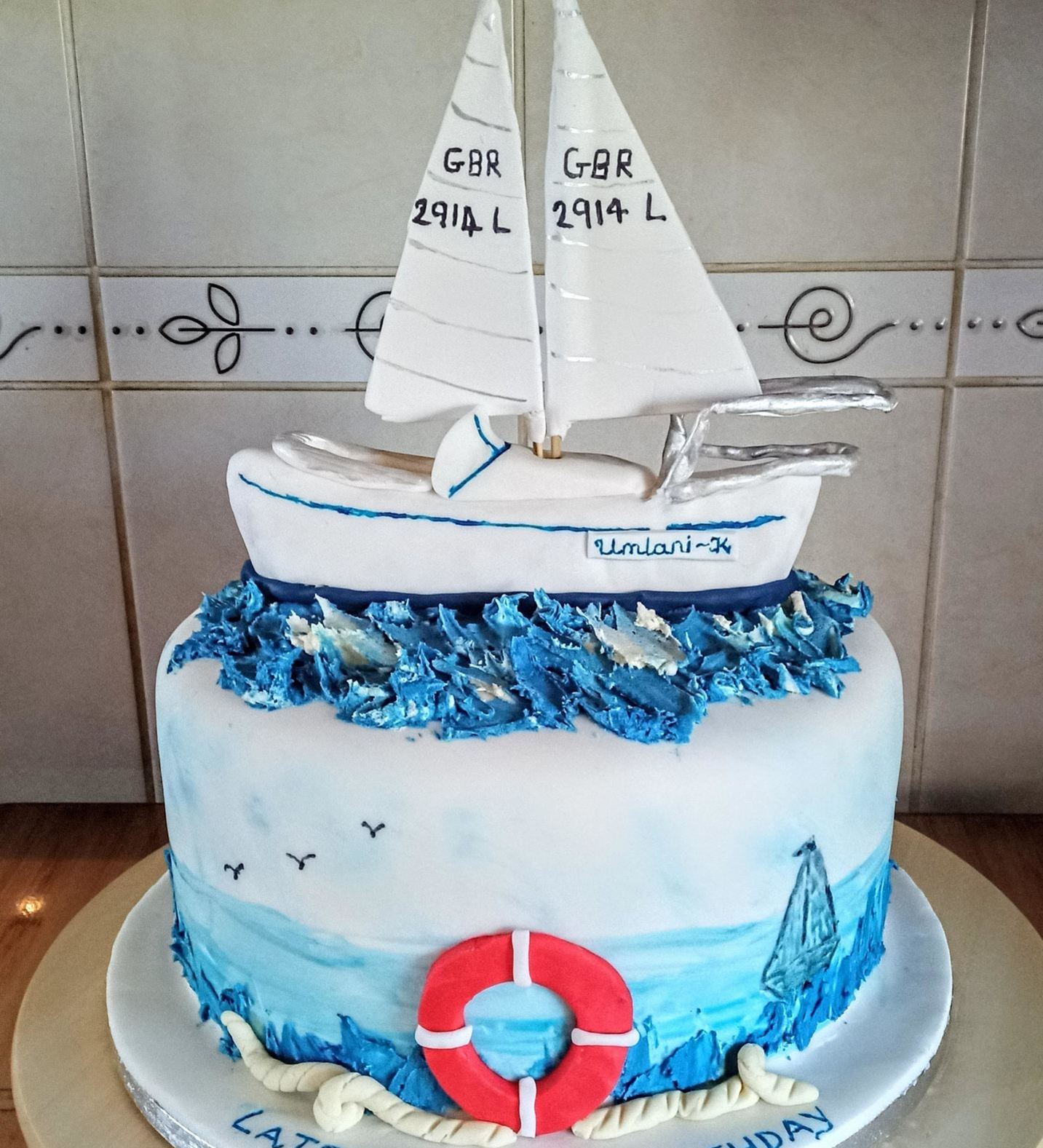 Novelty birthday cake with yacht cake topper