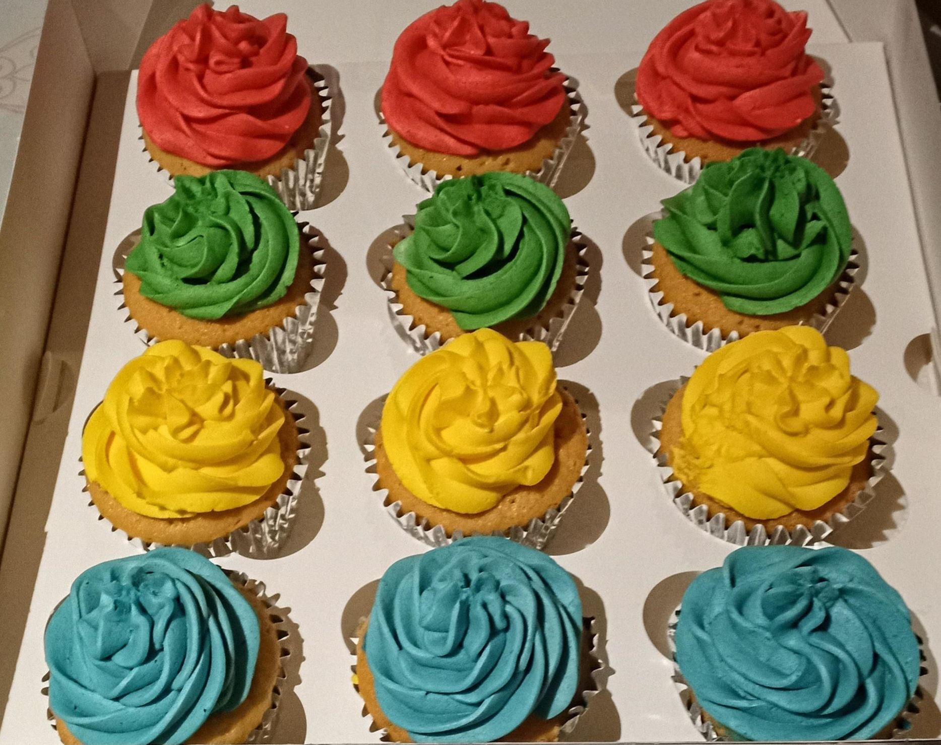 Vanilla cupcakes in 4 different colours