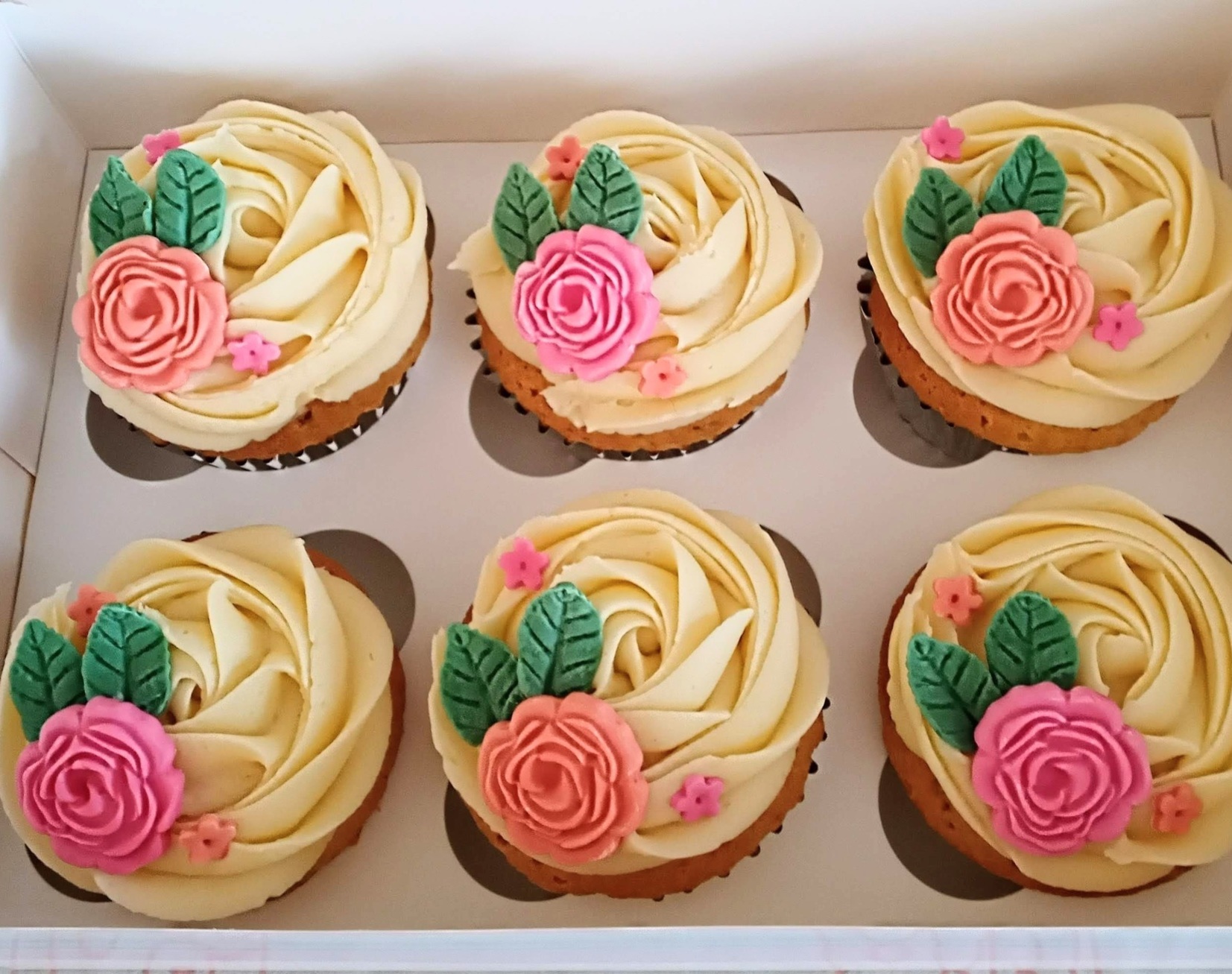 Vanilla cupcakes topped with sugar flowers