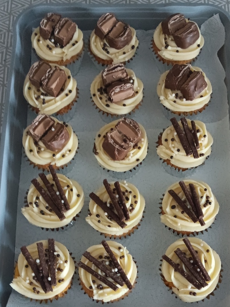 Birthday cupcakes topped with mars bars and matchmakers